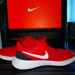Junior's Red and White Nike Revolutions Trainers.